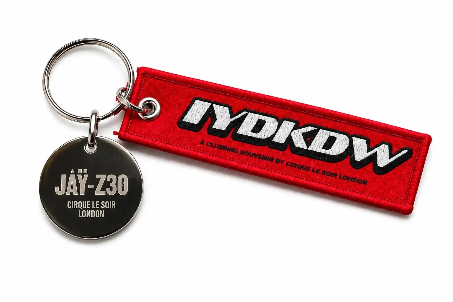 Bespoke Cirque Le Soir woven fabric keyring with red ribbon, custom embroidered NYDKDW logo and engraved JAY-Z30 metal tag